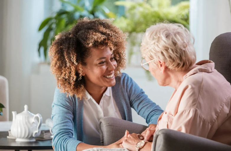 Home care caregiver engaging a dementia patient in healthy eating.