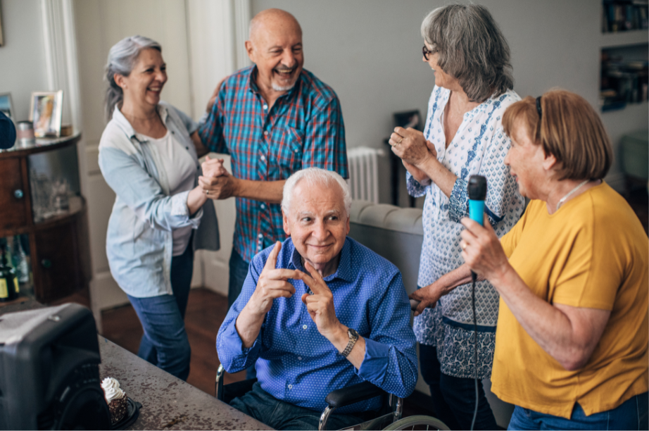 Stress free seniors having fun, singing karaoke and dancing in a group